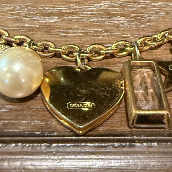 Coach Gold Tone Multi Charm Bracelet. Includes locket Heart, Bird, Star and more - Picture 13 of 17
